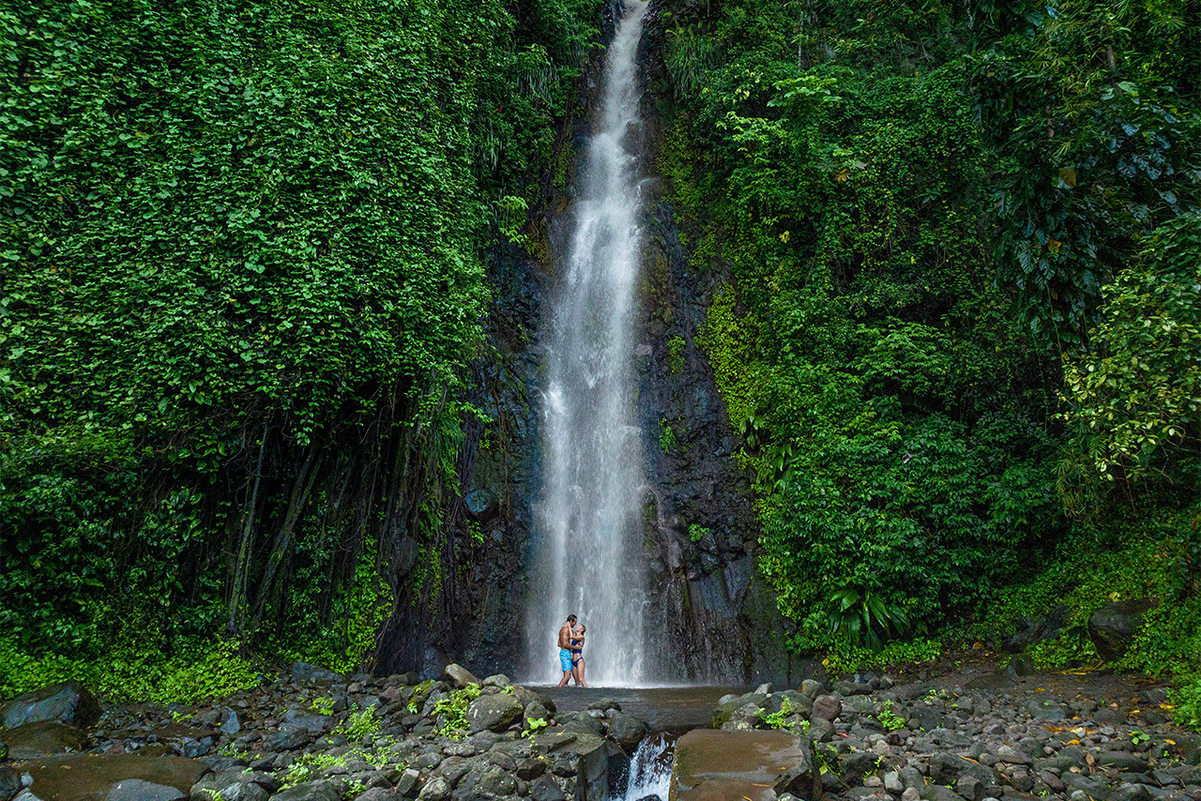 couple infront of a waterfall at Dark View Falls in Saint Vincent and the Grenadines